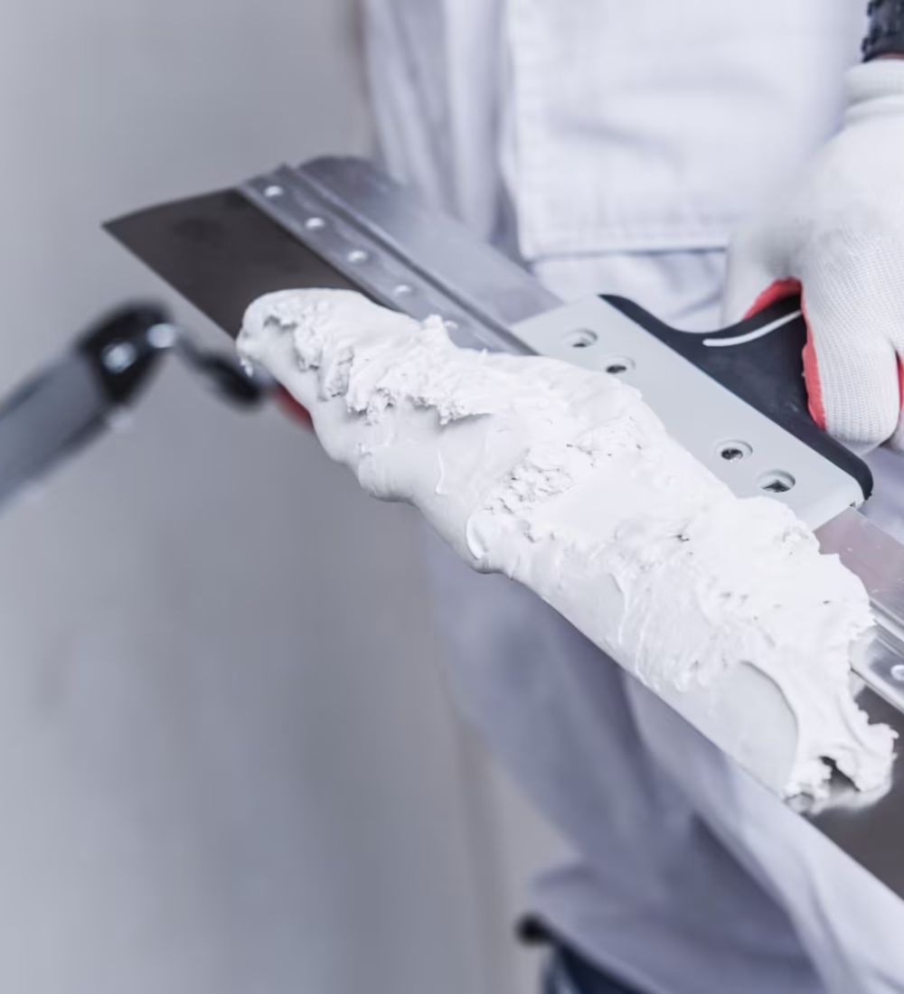 Preparing For Drywall Patch. Patching Tools in Hand of Worker Closeup Photo